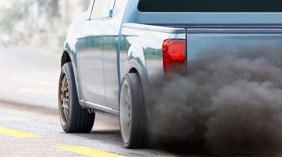 BG Services & How They Help Vehicle Emission Systems | Independent Auto and Diesel Repair in Jamestown, TN. Image of black smoke from a diesel vehicle’s exhaust pipe on road.
