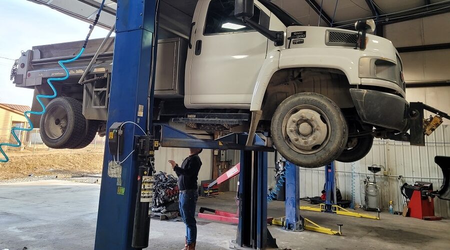 What To Expect from a Full-Service Auto Repair Shop | Independent Auto and Diesel Repair in Jamestown, TN. Image of a 15K-lb two-post rotary lift lifting a white pickup truck at an auto repair shop.
