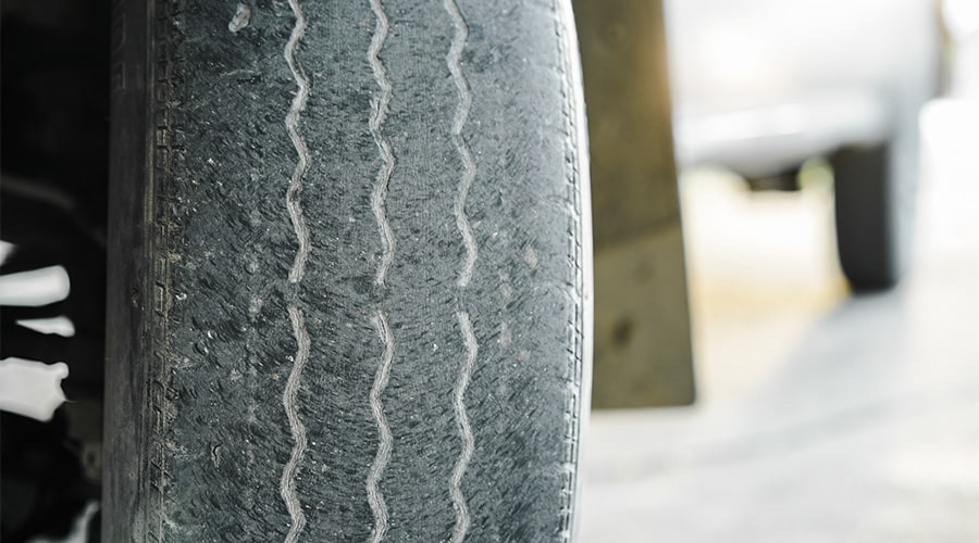 Close-up of an old worn tire or a bald tire not in good condition. Concept image of “5 Signs It’s Time to Replace Your Tires” | Independent Auto & Diesel Repair.
