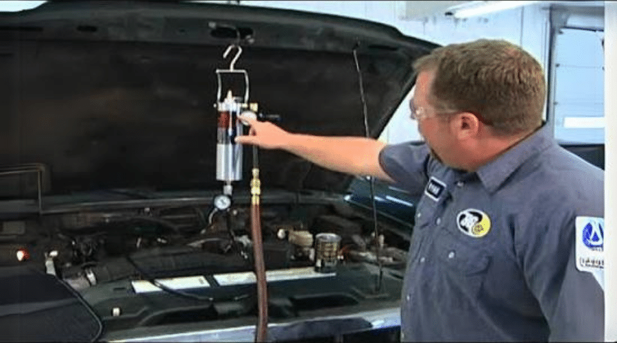 Does your car or truck need a fuel system cleaning in Jamestown, TN? Image of BG Services technician using their fuel system cleaning tool on car.