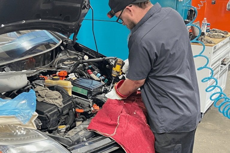 auto tax rebates, reliable auto repair, auto and diesel repair in Jamestown, TN at Independent Auto and Diesel Repair. Image of a mechanic performing repairs under the hood of a vehicle.