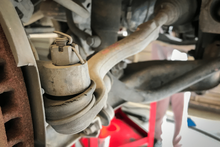 worn ball joints, reliable auto repair, auto and diesel repair in Jamestown, TN at Independent Auto and Diesel Repair. Close-up of a worn and cracked ball joint in a vehicle's suspension system.