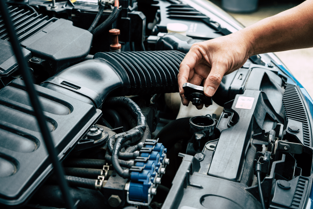 Car Cooling System Repair in Jamestown, TN At Independent Auto and Diesel Repair. Mechanic inspecting a vehicle radiator cap during cooling system repair service
